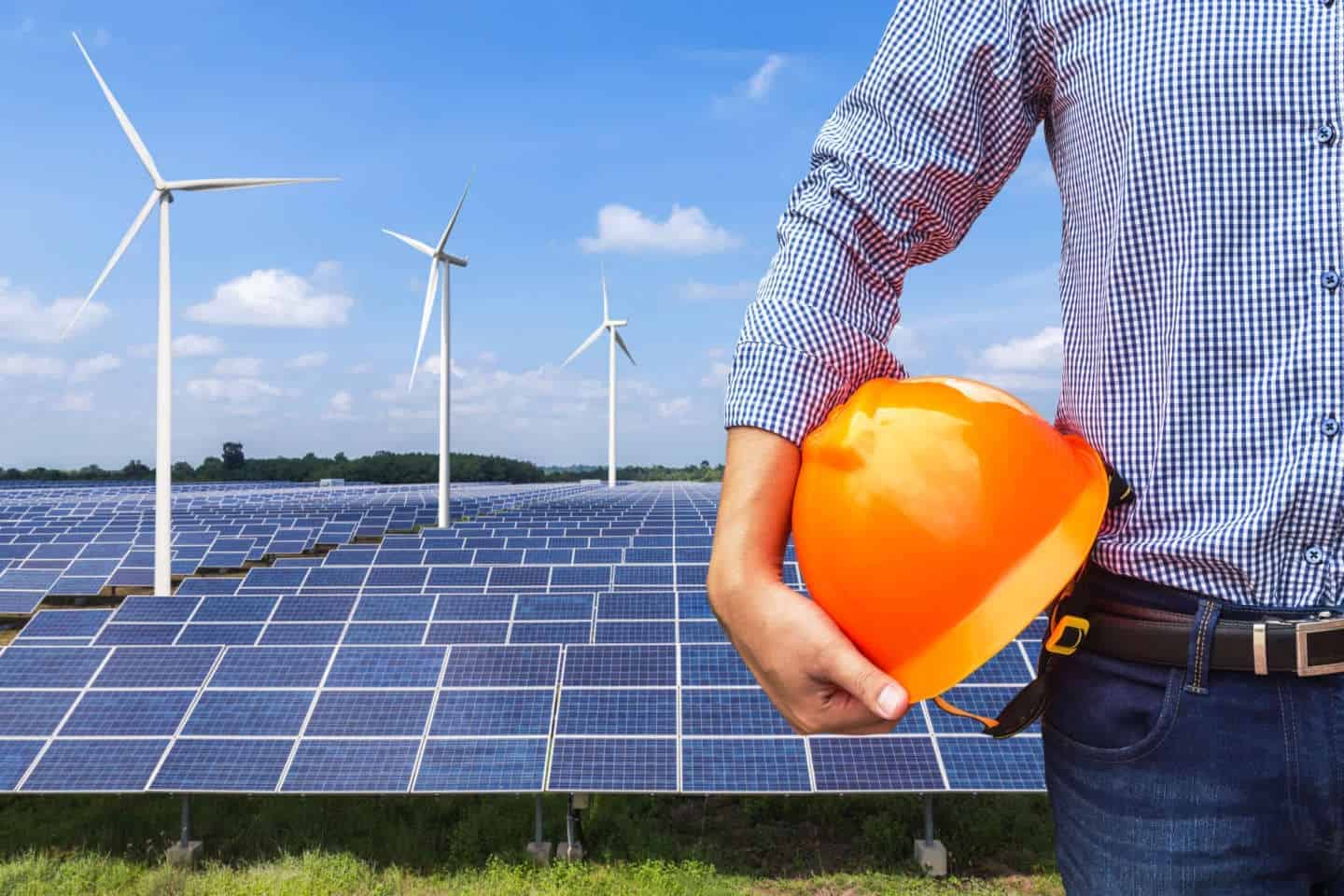 engineer stand holding yellow construction helmet front solar photovoltaic and wind turbines generating electricity power station