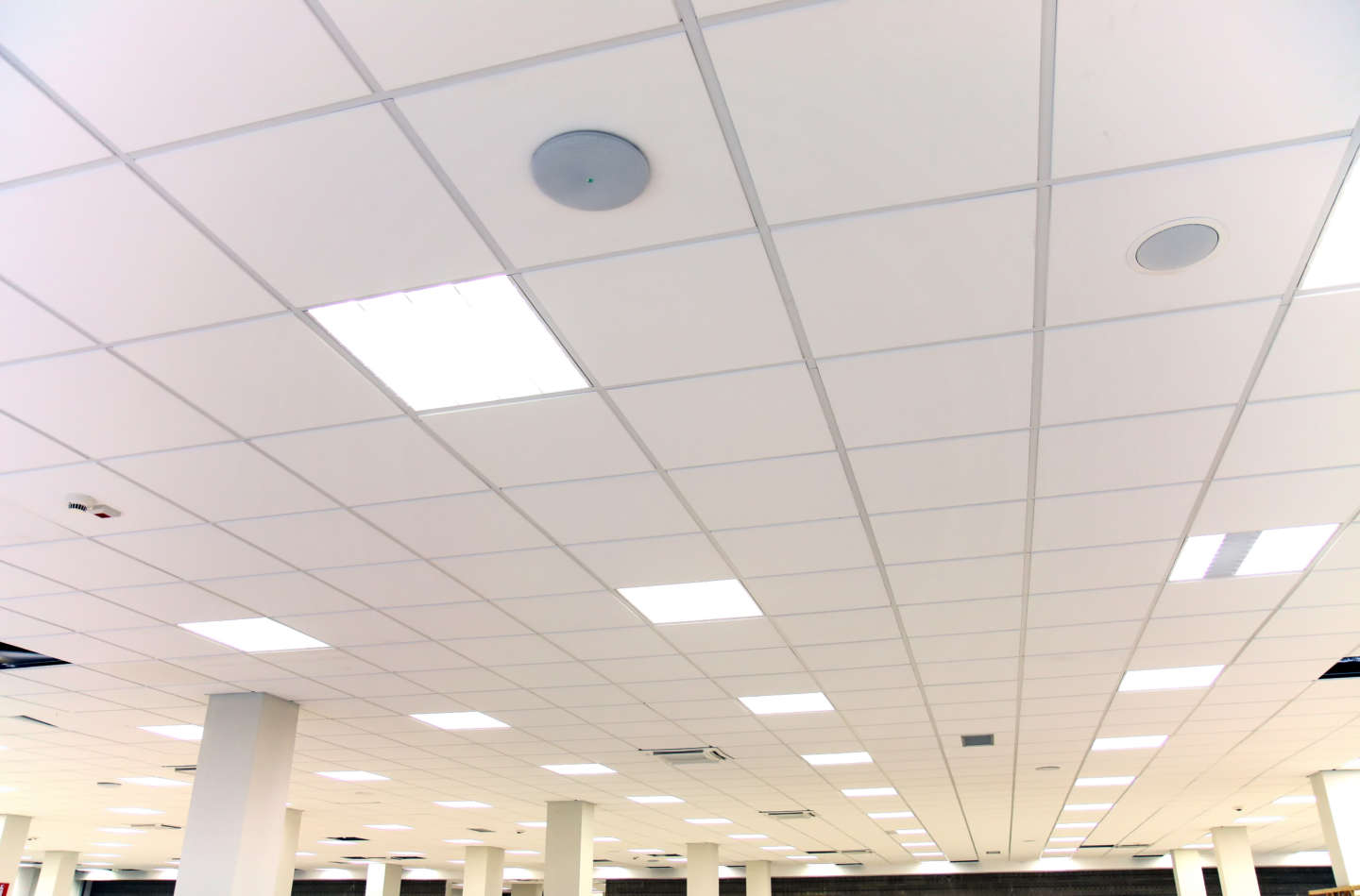 White office ceiling with white tiles and lighting