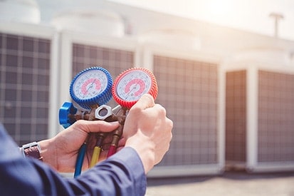 Hands measuring air conditioner system